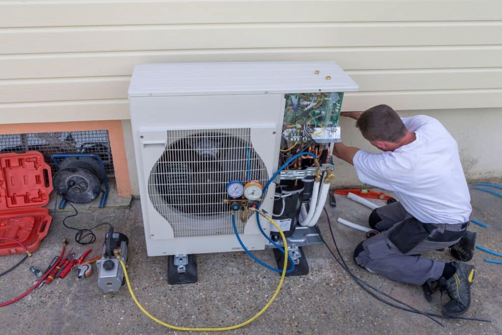 Professional installing a heat pump system